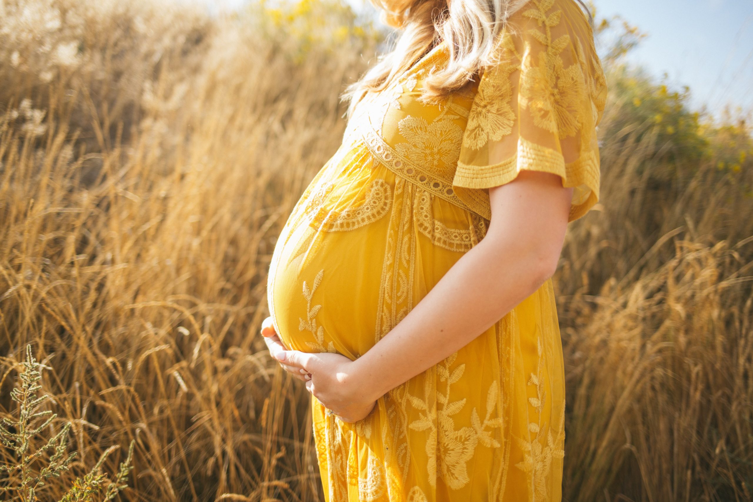 woman with pregnancy holding stomach