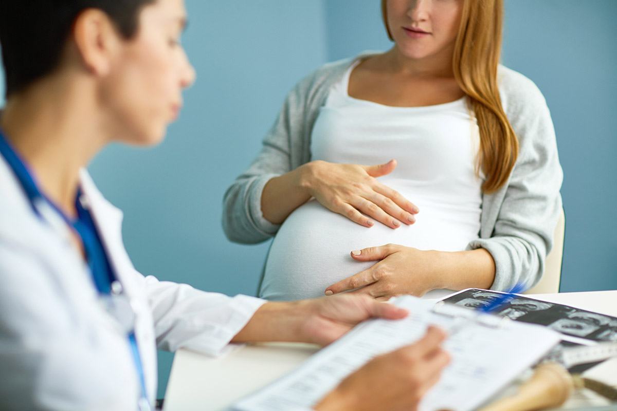 pregnant woman in a genetic testing consultation with doctor